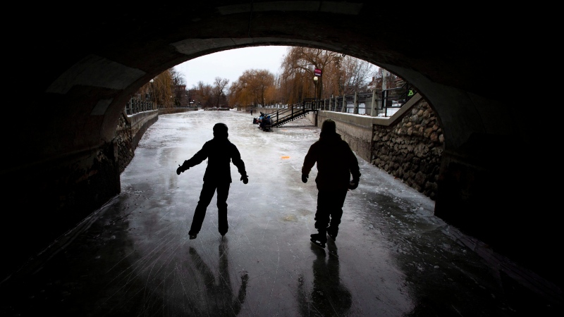 People skate under Queen Elizabeth Driveway to Paterson Creek on the Rideau Canal Skateway on its opening day, in Ottawa on Sunday, Dec. 30, 2018. (THE CANADIAN PRESS/Justin Tang)