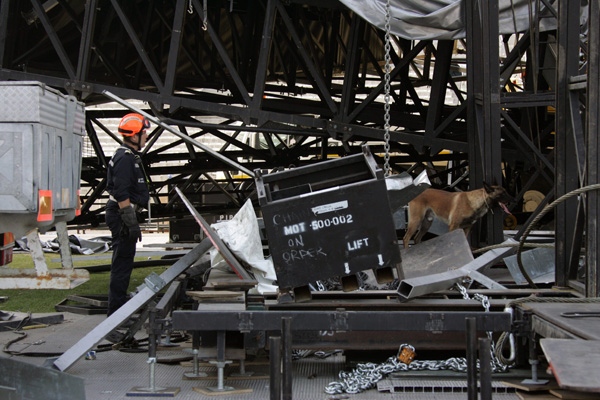 A firefighter and a search dog are seen near the stage being built for a Madonna concert that collapsed at the Stade Velodrome stadium in Marseille, southern France, Thursday, July 16, 2009. (AP / Elise Gardet Bataillon des Marins-Pompiers de Marseille-BMPM)