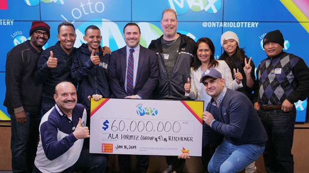 A group of coworkers poses with a giant cheque, after winning $60-million lottery jackpot, in Toronto in this Thursday, Jan. 10, 2019 handout photo. (THE CANADIAN PRESS/HO - OLG)