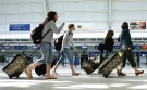 Travellers walk through Terminal 3 at Pearson International Airport in Toronto. (CP / Nathan Denette)