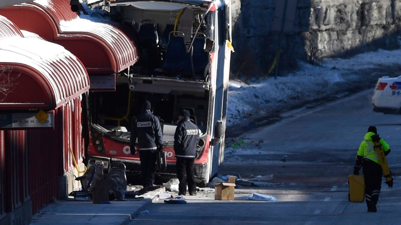 Transport Canada officials look at the scene where a double-decker city bus struck a transit shelter at the start of the afternoon rush hour on Friday, at Westboro Station in Ottawa, on Saturday, Jan. 12, 2019. THE CANADIAN PRESS/Justin Tang