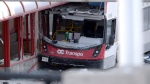 A double-decker city bus that struck a transit shelter at the start of the afternoon rush hour on Friday, remains in place at Westboro Station in Ottawa, on Saturday, Jan. 12, 2019. THE CANADIAN PRESS/Justin Tang