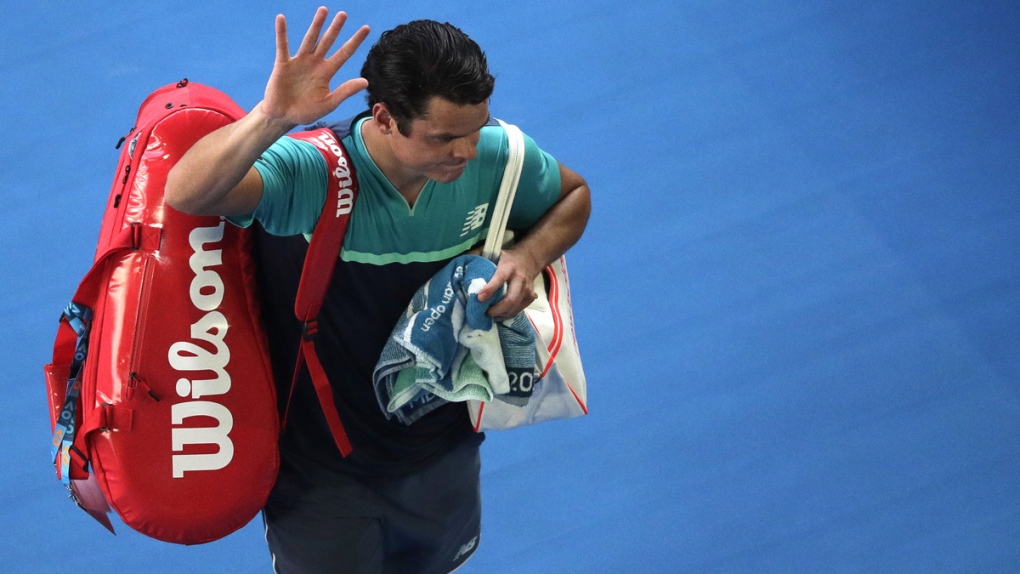 Milos Raonic waves as he leaves Rod Laver Arena