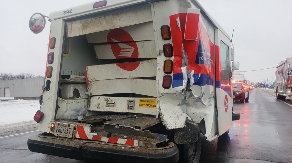 A postal truck significantly damaged
