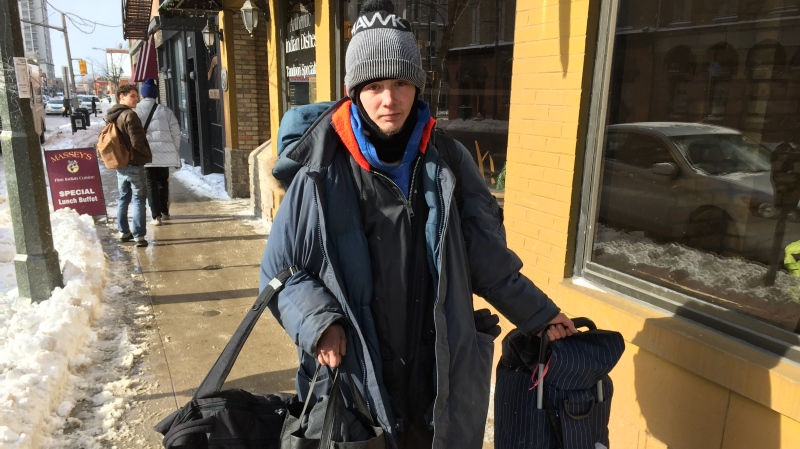 Devin Morris, 25, who is homeless and has been on the waitlist for social housing for three years, carries his belongings in London, Ont. on Wednesday, Jan. 30, 2019. (Bryan Bicknell / CTV London)