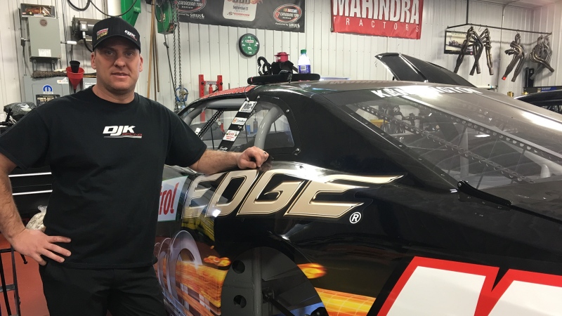 DJ Kennington stands next to his racecar in St. Thomas, Ont. on Wednesday, Jan. 30, 2019. (Brent Lale / CTV London)