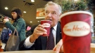 Ron Joyce, co-founder of Tim Hortons, sips a coffee in Toronto on Friday, October 20, 2006. Joyce has died at age age 88. THE CANADIAN PRESS/Aaron Harris