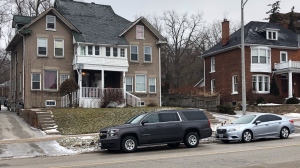 Unmarked police vehicles sit outside a home on Dunlop Street in Barrie, the focus of a human trafficking investigation on Tues., Feb.5, 2019 (CTV News/Mike Walker)