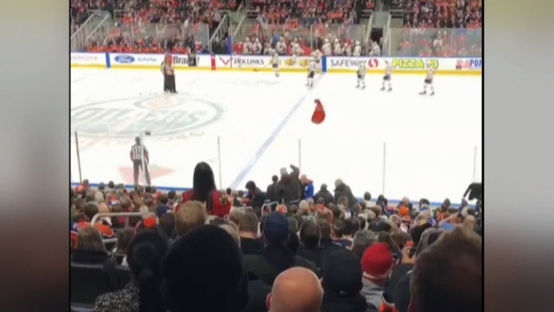 oilers fan throws jersey on ice