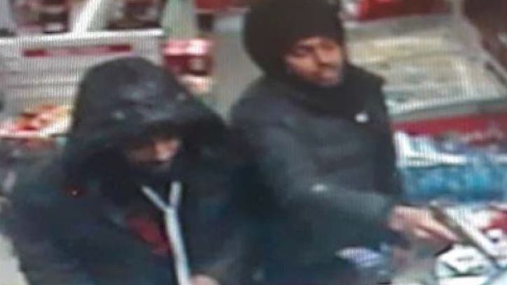 Two people during a robbery at a gas station