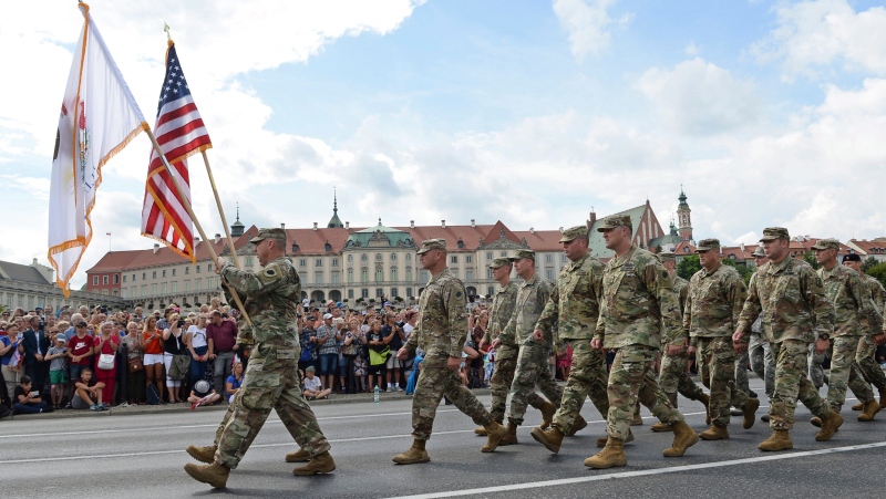In this Wednesday, Aug. 15, 2018 file photo, a group of US Army soldiers take part in an annual military parade celebrating Polish Army Day in Warsaw, Poland. The Polish government, which is closely aligned with President Donald Trump, has joined forces with the U.S. to co-host an international conference on the Middle East on Wednesday Feb. 12, 2019 and Thursday Feb. 13 in Warsaw. (AP Photo/Alik Keplicz, File)