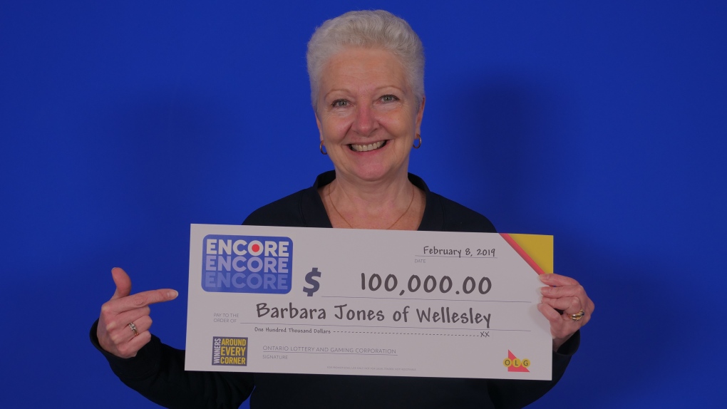 Barbara Jones posing with her $100,000 cheque