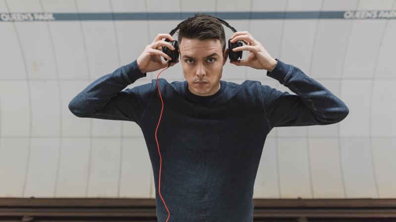 A person is seen putting on headphones in this file photo. (Burst / Pexels)