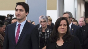 Prime Minister Justin Trudeau and Minister of Justice and Jody Wilson-Raybould take part in the grand entrance as the final report of the Truth and Reconciliation commission is released, Tuesday Dec. 15, 2015 in Ottawa. (THE CANADIAN PRESS/Adrian Wyld)