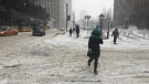 Pedestrians navigate a snowy sidewalk in downtown Toronto during a winter storm Tuesday February 12, 2019. (Joshua Freeman /CP24)