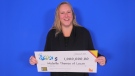 Michelle Thomas of Lucan, Ont. is seen holding her million-dollar cheque in this image provided by the Ontario Lottery and Gaming Corporation.