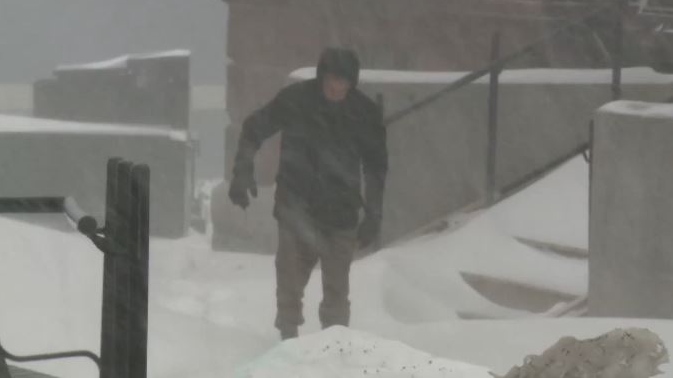 Dennis Oland trudges through a blizzard to the Saint John Law Courts for his murder trial on Feb. 13, 2019.
