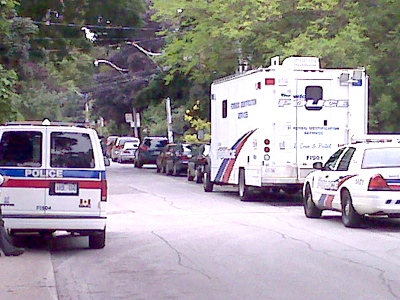 Police vehicles line a street outside an Annex-area bar