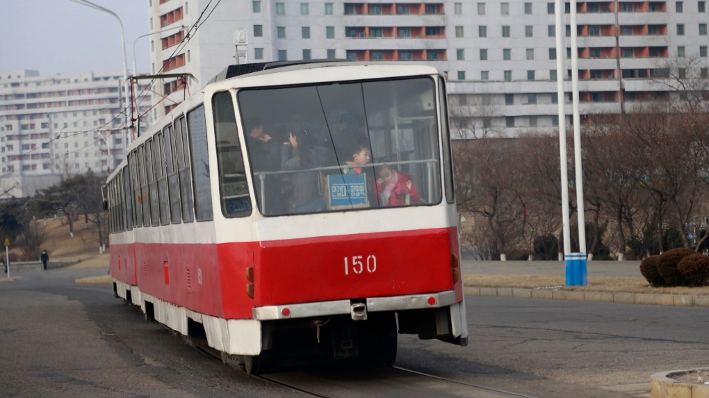 People ride on a tram in Pyongyang