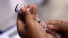 In this Monday, Aug. 6, 2018, file photo, a health worker prepares a syringe with a vaccine against measles in Rio de Janeiro, Brazil. (AP Photo/Leo Correa, File)