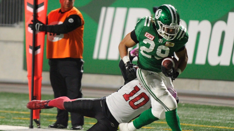 Saskatchewan Roughriders running back Kienan LaFrance (29) shakes off a tackle attempt by Ottawa Redblacks linebacker Serderius Bryant (10) for a touchdown during first half CFL action in Regina on Friday, October 13, 2017. (THE CANADIAN PRESS/Mark Taylor)