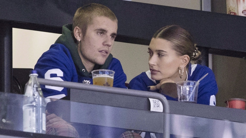 Justin Bieber watches alongside his wife Hailey Baldwin, right, during NHL hockey action between the Philadelphia Flyers and the Toronto Maple Leafs, in Toronto on Saturday, Nov. 24, 2018. (THE CANADIAN PRESS / Chris Young)