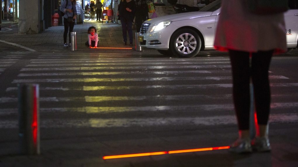 Embedded LED stoplight at a crosswalk in Tel Aviv