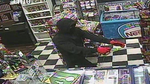 A suspect pointing a gun in a convenience store