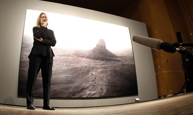 Annie Leibovitz stands in front of her work 'Monument Valley, Arizona 1993' as she speaks during a news conference promoting her exhibition 'A Photographer's Life 1990-2005,' in Berlin, Germany, Feb. 20, 2009. (AP / Michael Sohn)
