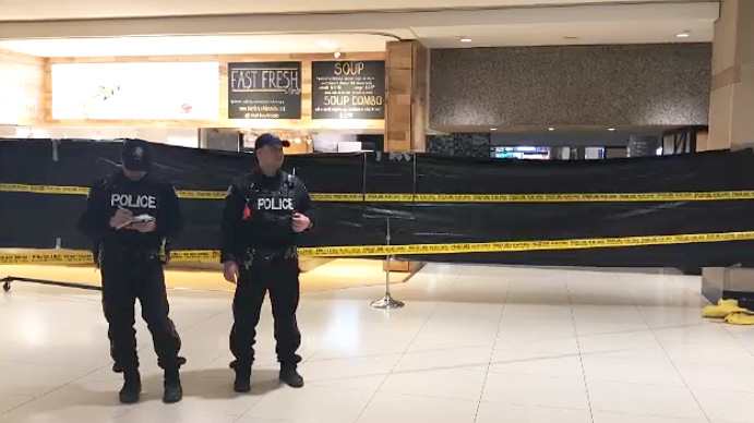  Toronto police officers guard a fast food stall in the city's PATH system on April 11, 2019 after a woman was stabbed to death one day earlier. 