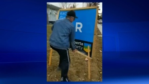 A homeowner damages a Gar Gar sign on his property in Calgary-East that his tenant had agreed to display (image courtesy: Gar Gar)