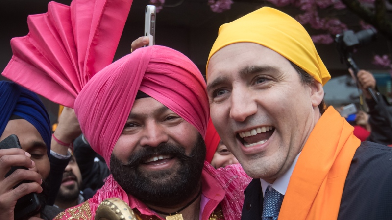 Prime Minister Justin Trudeau, right, poses for a photograph with Gurmukh Singh after marching in the Vaisakhi parade, in Vancouver on Saturday April 13, 2019. THE CANADIAN PRESS/Darryl Dyck