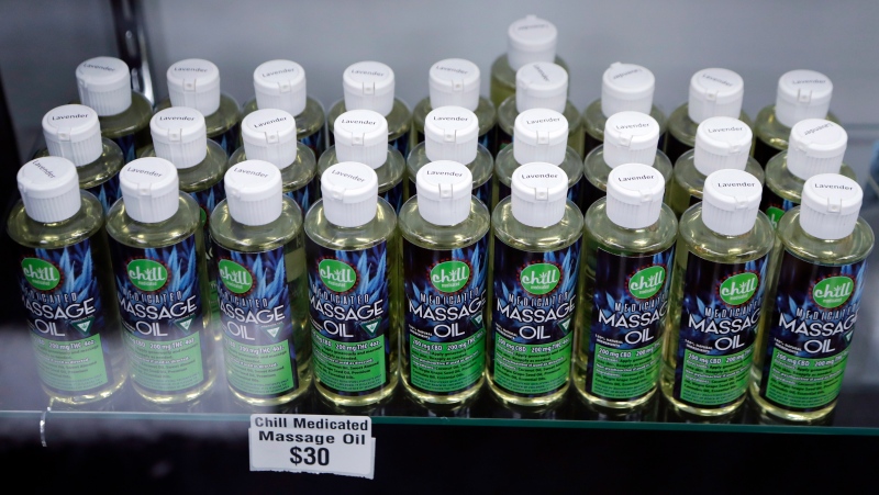 In this Nov. 7, 2018, file photo, bottles of massage oil with cannabidiol (CBD) and tetrahydrocannabinol (THC), two natural compounds found in plants of the Cannabis genus, are displayed at the Far West Holistic Center dispensary in Detroit. (AP Photo/Carlos Osorio, File)