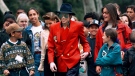 In this April 18, 1995, file photo, pop star Michael Jackson and Lisa Marie Presley, behind him at left, walk with children that were invited guests at his Neverland Ranch home in Santa Ynez, Calif. (AP Photo/Mark J. Terrill)