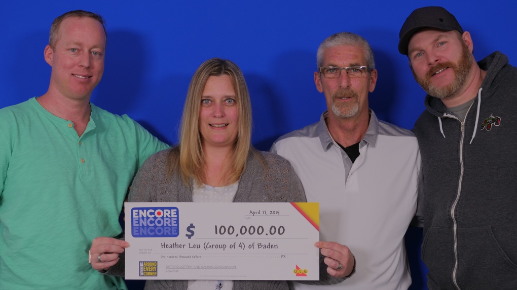 Four people posing with their OLG cheque