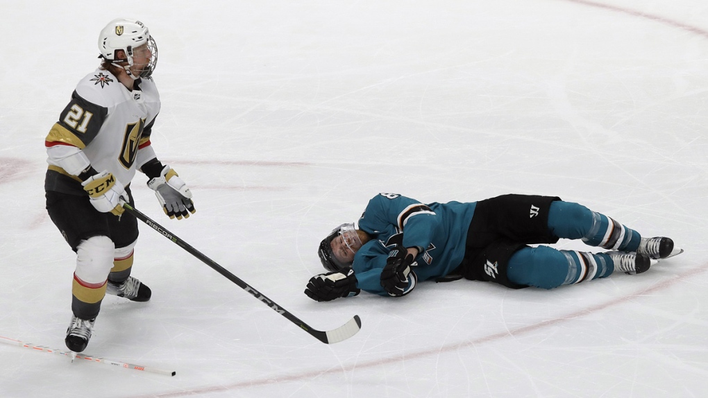 Joe Pavelski, right, lies on the ice