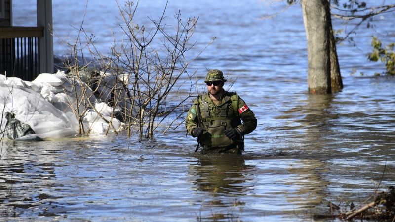 A Canadian soldier works to hold back floodwaters on the Ottawa River in Fitzroy, Ont. on Monday, April 29, 2019. THE CANADIAN PRESS/Sean Kilpatrick