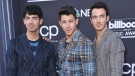 FILE - This May 1, 2019 file photo shows Joe Jonas, from left, Nick Jonas and Kevin Jonas, of the Jonas Brothers, at the Billboard Music Awards in Las Vegas. (Photo by Richard Shotwell/Invision/AP, File)