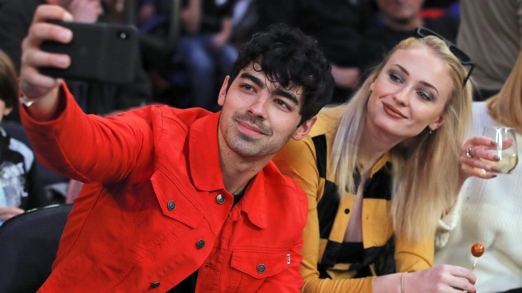Joe Jonas, left, takes a selfie with Sophie Turner