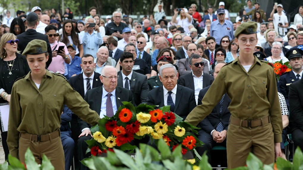 Israeli soldiers hold a wreath