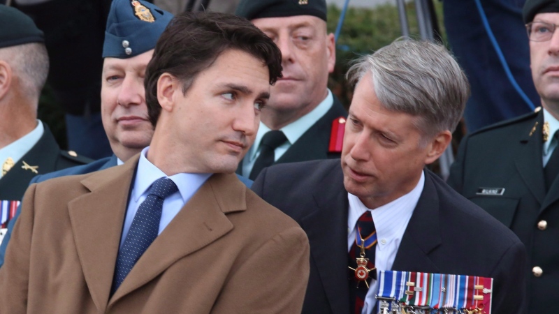 Justin Trudeau speaks with Andrew Leslie prior to a ceremony marking the one year anniversary of the attack on Parliament Hill on Thursday Oct. 22, 2015 at the National War Memorial in Ottawa. THE CANADIAN PRESS/Fred Chartrand