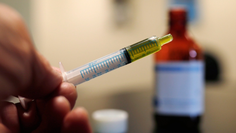 A syringe loaded with a dose of CBD oil is shown in a research laboratory at Colorado State University in Fort Collins, Colo., on November 6, 2017. THE CANADIAN PRESS/AP, David Zalubowski