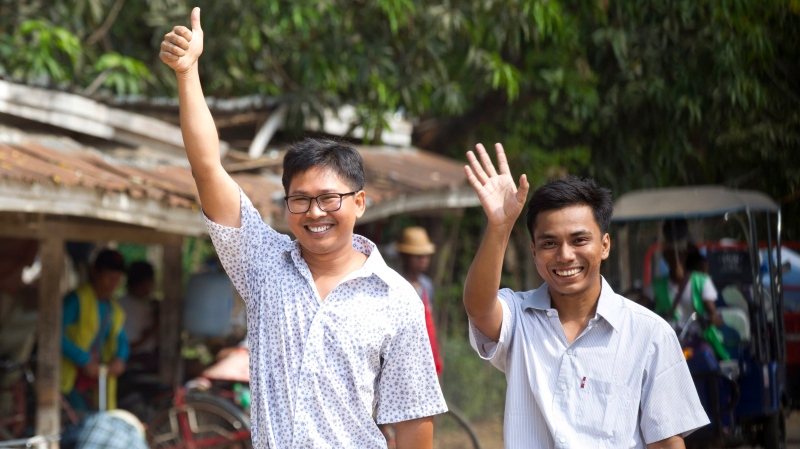 Reuters journalists Wa Lone, left, and Kyaw She Oo wave as they walk out from Insein Prison after being released in Yangon, Myanmar Tuesday, May 7, 2019. (AP Photo/Thein Zaw)