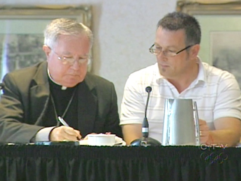 Bishop of Antigonish Raymond Lahey signs a $13 million class action lawsuit settlement with sexual abuse survivor Ron Martin in Halifax on Friday, Aug. 7, 2009.