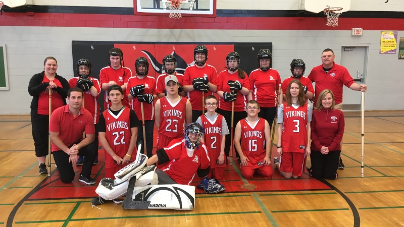 Members of the basketball and floor hockey teams at Arthur Voaden Secondary School pose in St. Thomas, Ont. on Wednesday, May 8, 2019. (Brent Lale / CTV London)