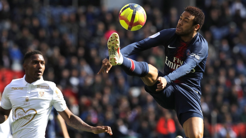 PSG's Neymar, right, controls the ball 