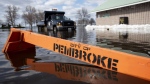 Floodwaters from the Ottawa River nearly cover a road sign in Waterfront Park in Pembroke, Ont., Saturday, May 11, 2019. (THE CANADIAN PRESS/Justin Tang)