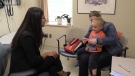 Dr. Samiry Jeimy, left, speaks with Luke and his mom Kelly Straatman, in London, Ont. on Monday, May 13, 2019. (Celine Moreau / CTV London)