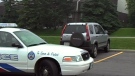 Police surround a vehicle where a woman says she was held at gunpoint before escaping, on Aug. 9, 2009.