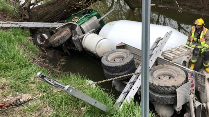 A cement truck in a creek